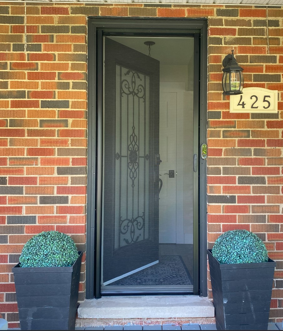 Mirage retractable screen door professionally installed on a front entry in Oakville