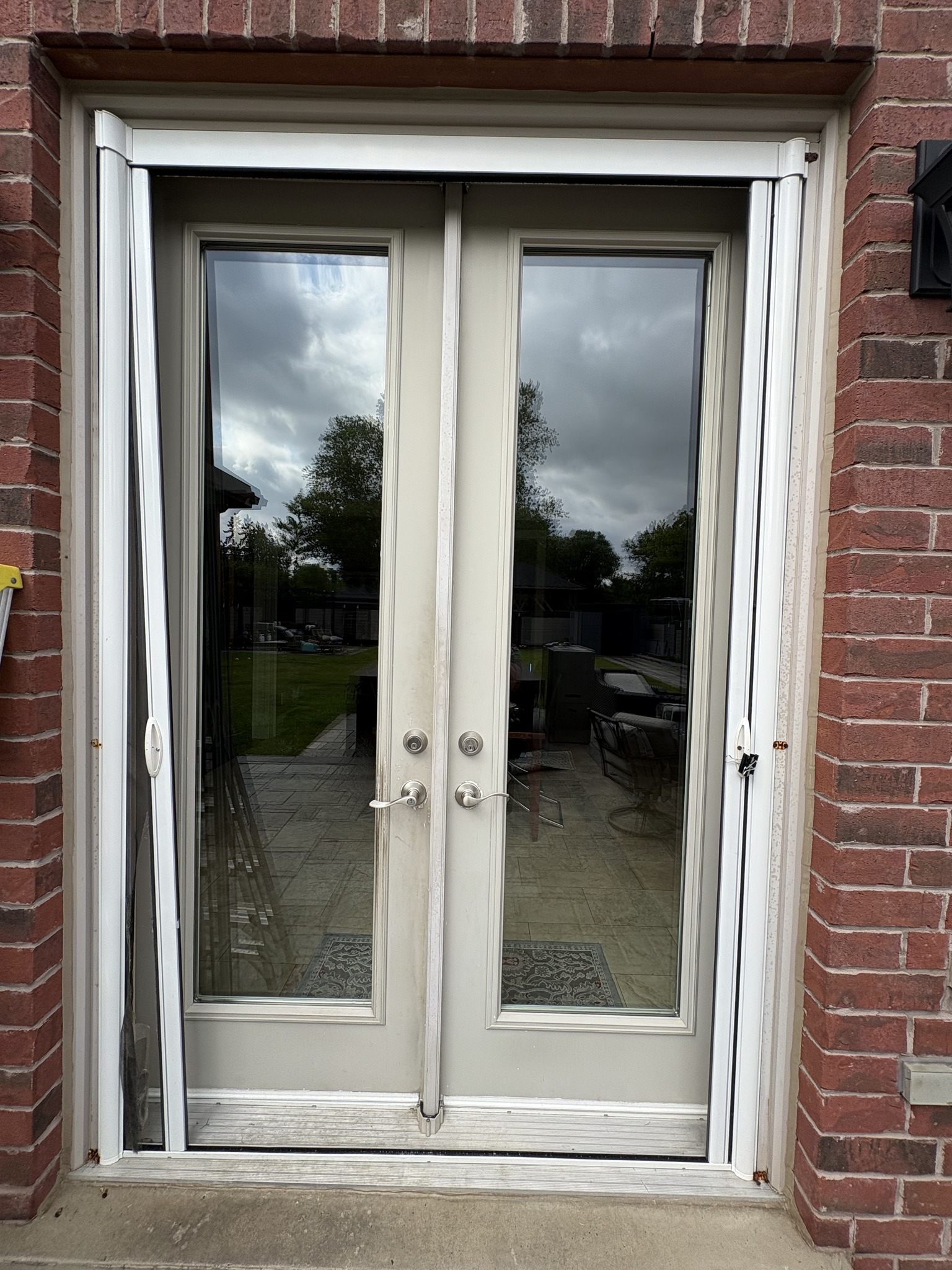 DIY retractable screen before replacement showing misaligned frame and gaps